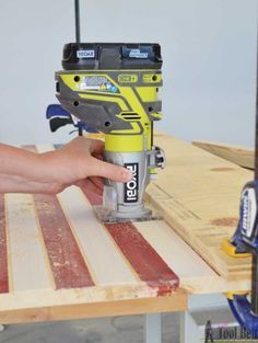 a person using a driller on a wooden table