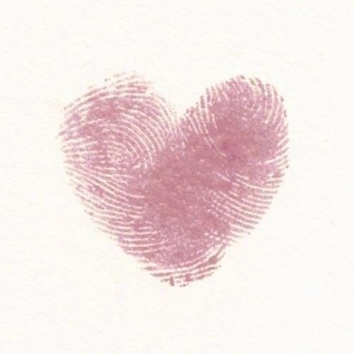 a fingerprint in the shape of a heart on a piece of white paper with pink ink