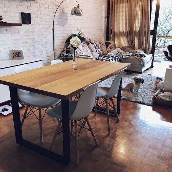 a living room filled with furniture and a wooden table