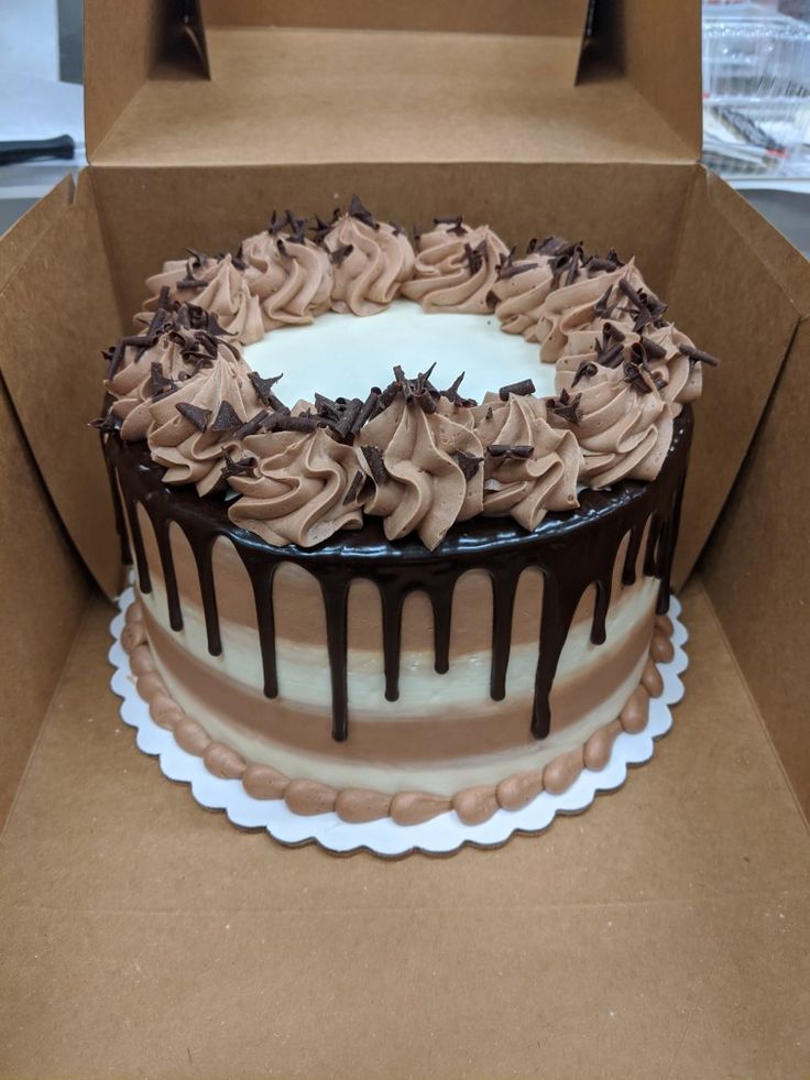 a cake in a box with chocolate icing on top