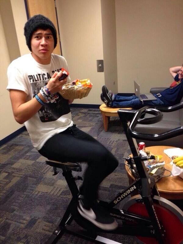 a man sitting on top of a bike eating food