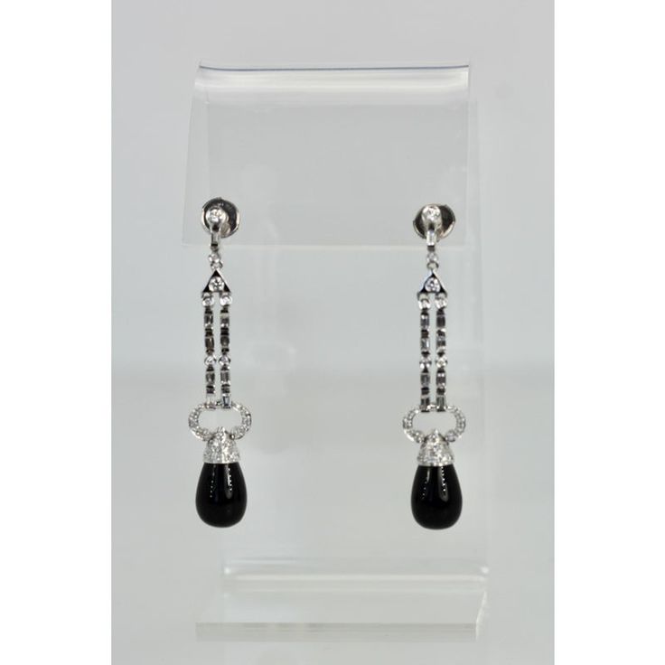 This is part of Chairish’s Fine Jewelry assortment.  These lovely earrings are set with round Diamonds, baguette Diamonds and pave Diamonds all with an Onyx drop. They are 2 1/4" long, Onyx is 9.17cm wide x 12.55cm long and weight 11.9 grams. These earrings are from Spain and the setting is gorgeous, baguettes alternate between round Diamonds with a pave of Diamonds heading the Onyx. Perfect you will keep these in your collection forever. I love black onyx and I do have a few important pieces bu Classic Polished Diamond Earrings For Evening, Elegant Linear Drop Earrings With Polished Finish, Evening Jewelry With Baguette Cut, Elegant Drop Diamond Earrings For Formal Occasions, Elegant Evening Jewelry With Baguette Cut, Elegant Baguette Cut Jewelry For Evening, Diamond Drop Linear Earrings For Evening, White Gold Baguette Cut Earrings For Evening, Luxury Pierced Diamond Earrings For Evening