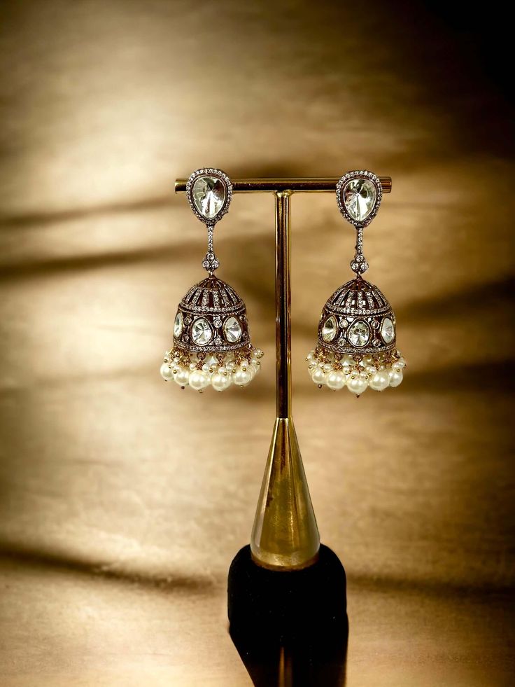 Unleash your daring side with our Diamond and Polki Jhumka earrings. Embellished with shimmering diamonds and traditional polki design, these earrings add a touch of elegance to any outfit. Take a leap and elevate your style with these captivating jhumkas! Luxury Heavy Round Jhumkas, Luxury Bollywood Chandbali Jhumkas, Luxury Ornate Jhumkas For Diwali, Luxury Jeweled Temple Jewelry Jhumkas, Luxury Festive Jhumkas, Luxury Heavy Jhumkas For Navratri, Luxury Jhumkas For Diwali, Affordable Wedding Jhumkas For Diwali, Polki Earrings Buttalu