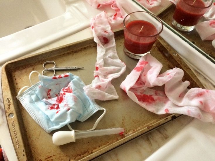 an old tray with some blood on it and two glasses next to it that are sitting on the table