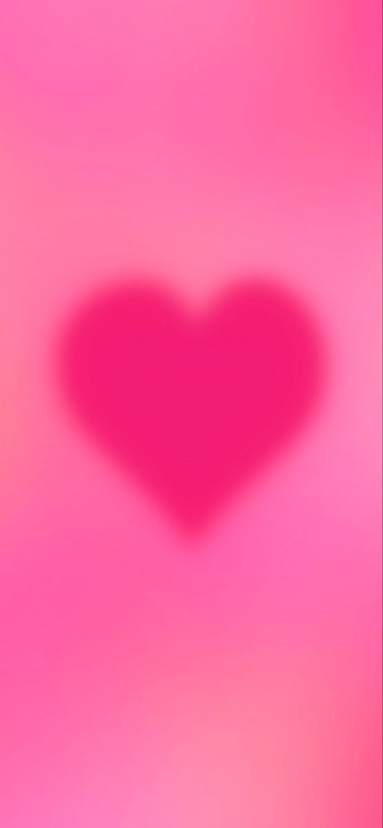 a blurry image of a heart on a pink background