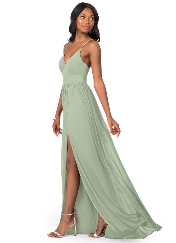 a woman wearing a long green dress with high slits on the side and an open back