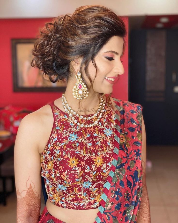 a woman wearing a red and blue sari