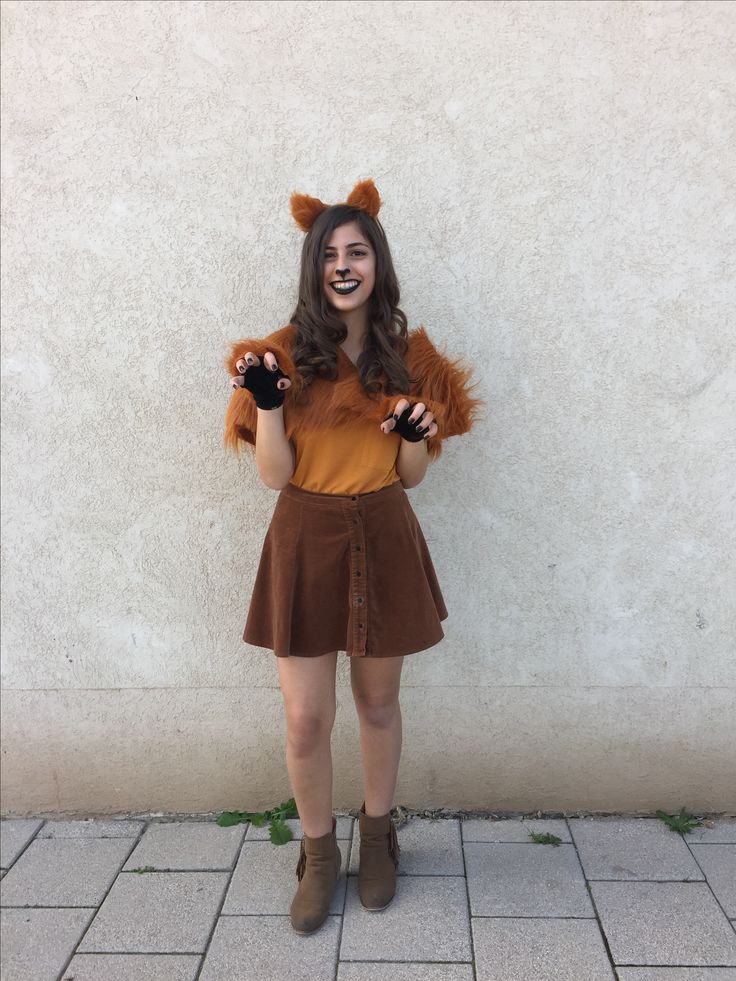 a woman wearing a brown dress and furry animal ears