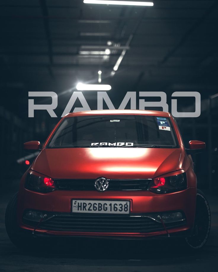 a red car parked in a garage with the word rambo on it