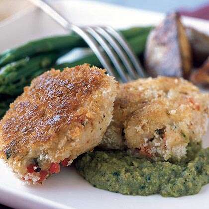 a white plate topped with meat patties and green beans