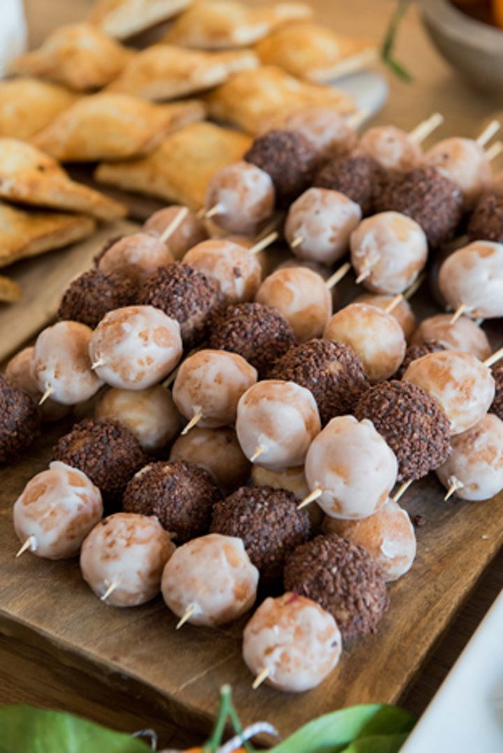 there are many desserts on the table with toothpicks stuck in each one