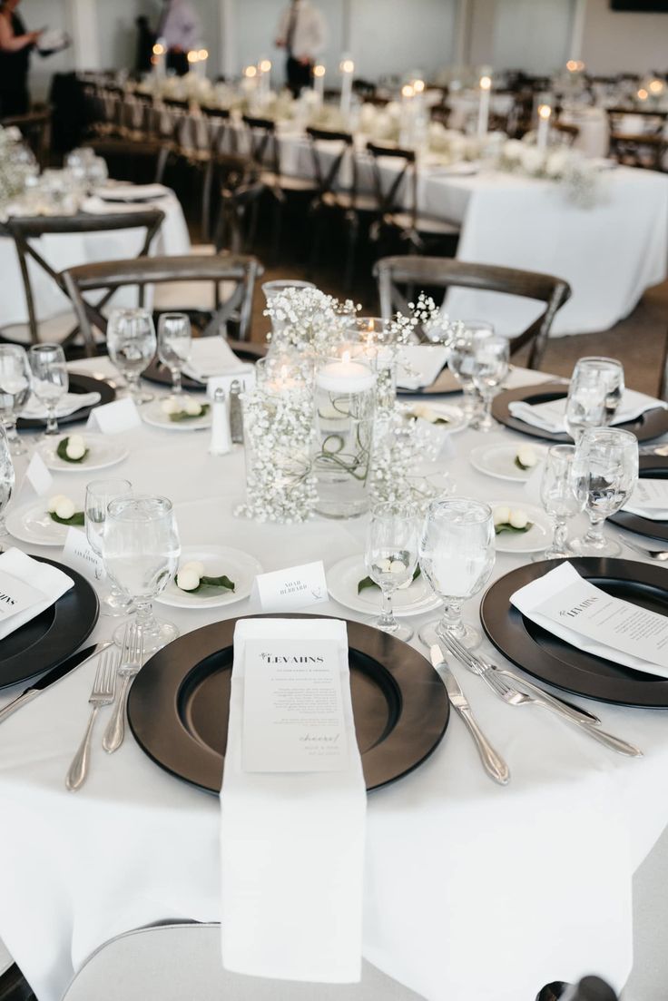 the table is set with black and white place settings