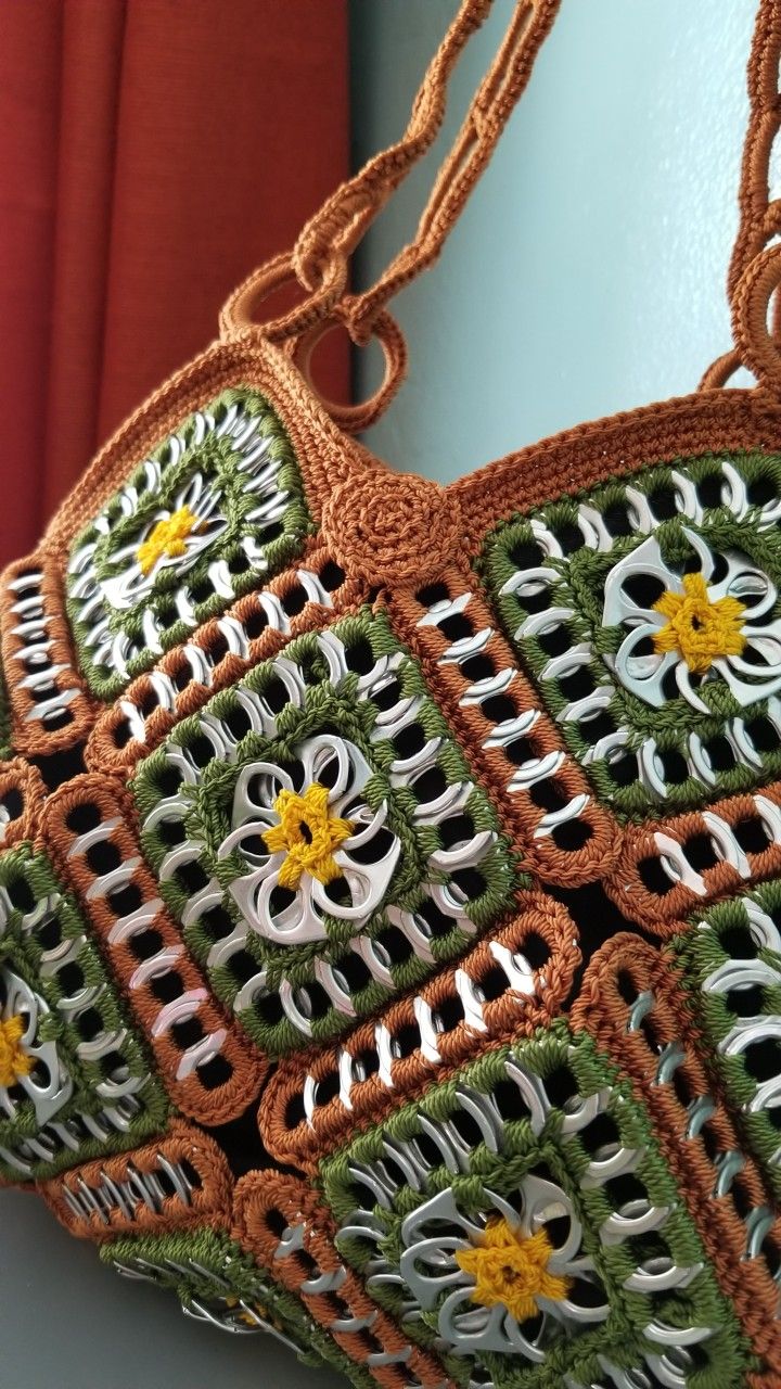 a crocheted purse hanging on a wall