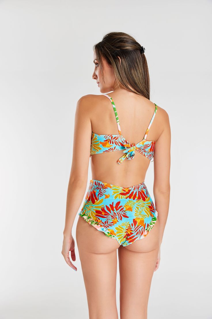 Make a statement with our eye-catching twist-front bikini set, designed to accentuate the bust and elevate your beach style. The high-waisted flutter bottom adds a playful touch to the ensemble. The padded strapless top not only ensures better support and durability but also features an adjustable string tying around the neck and a wider strap at the back for a secure fit. Enjoy the benefits of tummy control for a flattering silhouette. The classic brief sits comfortably across the middle of your hips, providing good coverage and a timeless look. Immerse yourself in this thoughtfully designed bikini set that effortlessly combines fashion, support, and comfort for a beach-ready look. Strapless Tropical Print Swimwear For Pool, Strapless Tropical Print Swimwear, Underwire Swimwear With Twist Front For Beach Season, Underwire Twist Front Swimwear For Beach Season, Twist Front Underwire Swimwear For Beach Season, Multicolor Swimwear With Removable Bra Pads For Vacation, Vacation Multicolor Swimwear With Removable Bra Pads, Beachwear Swimwear With Twist Front And Underwire, Underwire Twist Front Swimwear For Beachwear