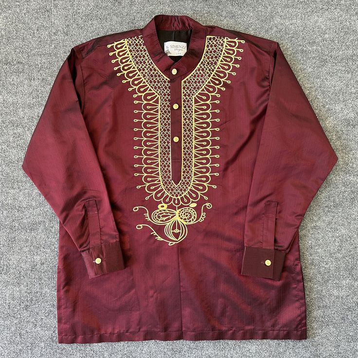 Introducing the Zorora Long Sleeve Shirt by Simenzz Designs. This stylish T-Shirt features intricate embroidery accents that add a touch of African flair to any outfit. It comes in a variety of sizes, from S to XXXL, and is perfect for men who want to make a statement. The shirt is made in the United States and is available in a rich burgundy color. The long sleeve design is perfect for cooler weather, making it a versatile addition to any wardrobe. Choose the Zorora Long Sleeve Shirt for a unique, eye-catching piece that is sure to turn heads. Pants are sold separately. Purchase both shirt and pants for a discounted price.  Message us for deal! Traditional Short Sleeve Tops For Eid, Short Sleeve Tops For Eid Festivities, Festive Short Sleeve Tops For Eid, Festive Fitted Embroidered Shirt, Traditional Fitted Crew Neck Top, Traditional Fitted Tops With Motif, Traditional Long Sleeve Festive Shirt, Fitted Traditional Motif Tops, Fitted Long Sleeve Tops For Eid