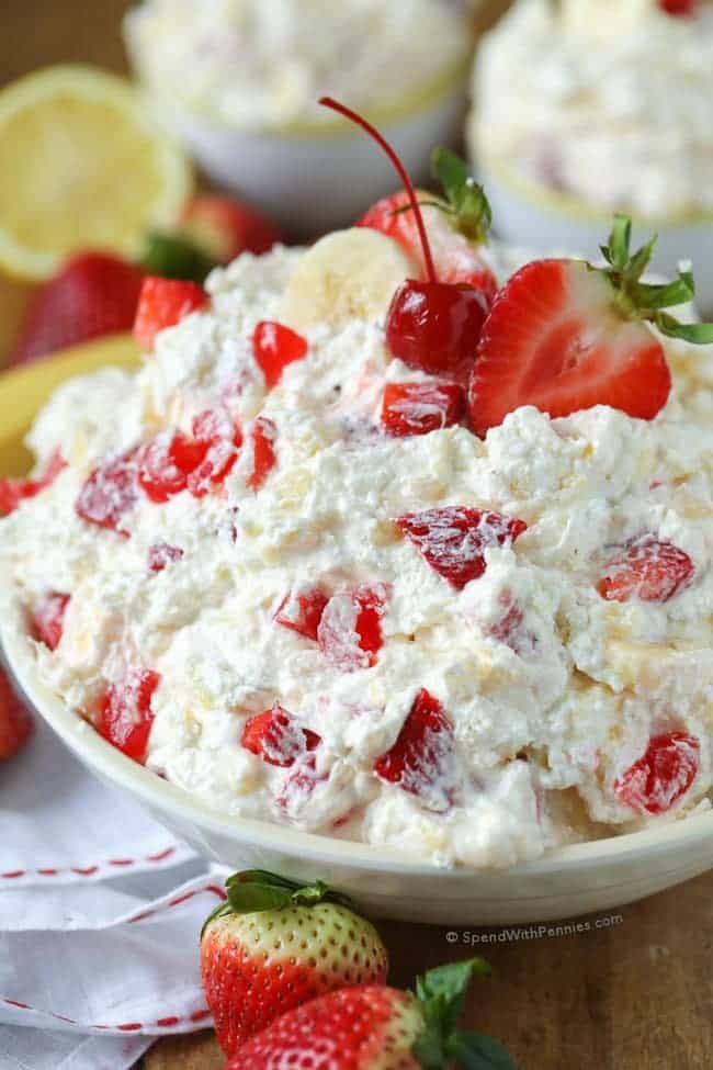 strawberry banana salad in a bowl with strawberries on the side