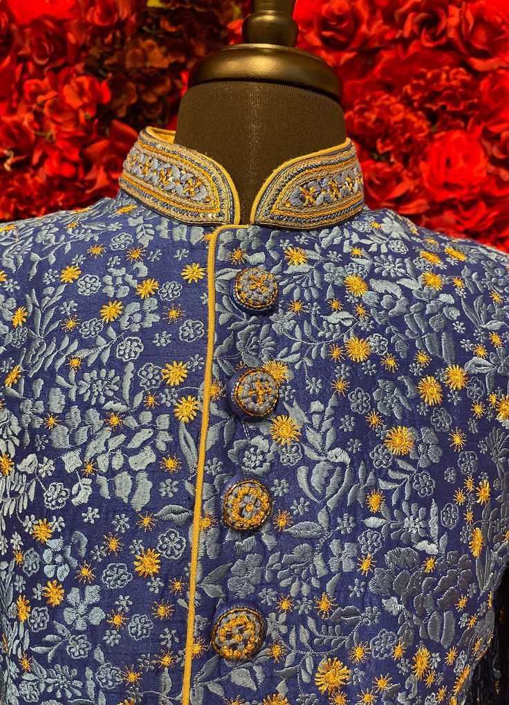 A regal blue sherwani adorned with intricate floral embroidery in gold and silver tones. The high-collared design and detailed buttons exude sophistication, making it perfect for weddings and grand celebrations. The luxurious fabric and rich embroidery make this sherwani a statement piece for any groom or special occasion. Key Features: Color: Royal blue with gold and silver floral embroidery. Design: High-collared with ornate buttons. Fabric: Rich, textured fabric for a luxurious feel. Occasion Buy Lehenga Online, Indian Bridal Couture, Blue Sherwani, Weddings Elegant, Elegant Veils, Reception Gowns, Mehendi Outfits, Bridal Store, Bridal Lehenga Red