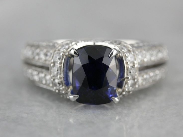 This sapphire statement ring has one of the finest sapphire currently mounted in our collection. Mined, cut and polished in Sri Lanka, this collector's quality gem is the perfect shade of blue, a wonderfully deep cornflower shade that is the benchmark for sapphire. Weighing in at over three carats, this investment piece is substantial, yet perfectly balanced by the diamond and modern white gold setting in which we've set it. Please feel free to contact us for more information about this gem. Met Asscher Cut Sapphire Ring With Diamond Detail, Timeless Sapphire Rings With Lab-created Sapphire, Luxury Lab-created Sapphire Ring For Formal Occasions, Classic Gia Certified Sapphire Ring, Luxury Sapphire Cushion Cut Ring, Fine Jewelry Sapphire Ring With Cushion Diamond Cut, Gia Certified Sapphire Diamond Ring In Timeless Style, Luxury Sapphire Birthstone Ring For Formal Occasions, Gia Certified Timeless Sapphire Diamond Ring