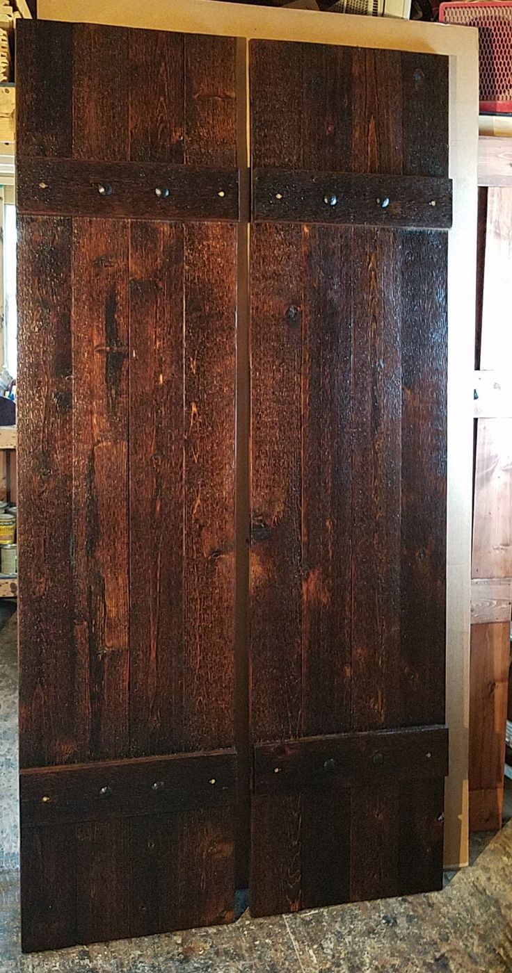 two wooden doors sitting next to each other on top of a counter in a room