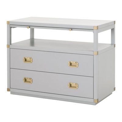 a white and gold dresser with two drawers on it's sides, against a white background