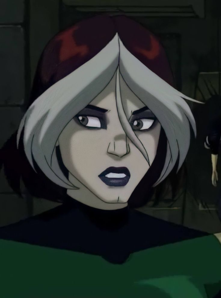 an animated image of a woman with grey hair and green shirt looking at the camera