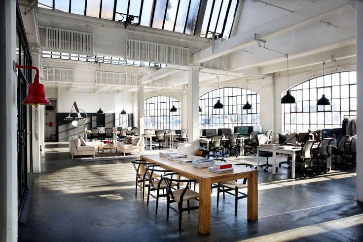 an open office with lots of desks and chairs in the middle of the room