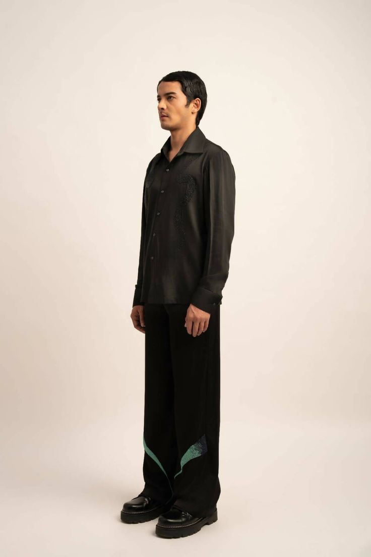 Made in IndiaElevate your ensemble with The Onyx Shirt—a regular-fit black satin masterpiece. Imbued with understated luxury, meticulously crafted black hand beadwork details adorn the shirt, adding a refined touch to your sophisticated style.FabricsShell: Viscose Moss Crepe Satin, IndiaMaintenance• Dry Clean Only• Do Not Bleach• Steam Iron OnlyModel is wearing UK Size Medium, Height 181 cmXS: 36 inches (bust), 33 inches (waist), 38 inches (hips)S: 38 inches (bust), 35 inches (waist), 40 inches Luxury Collared Tops For Evening, Luxury Long Sleeve Evening Shirt, Designer Black Semi-formal Top, Silk Collared Shirt For Evening, Silk Collared Evening Shirt, Designer Black Tops For Semi-formal Occasions, Evening Silk Collared Shirt, Black Silk Shirt For Formal Occasions, Black Relaxed Fit Formal Top