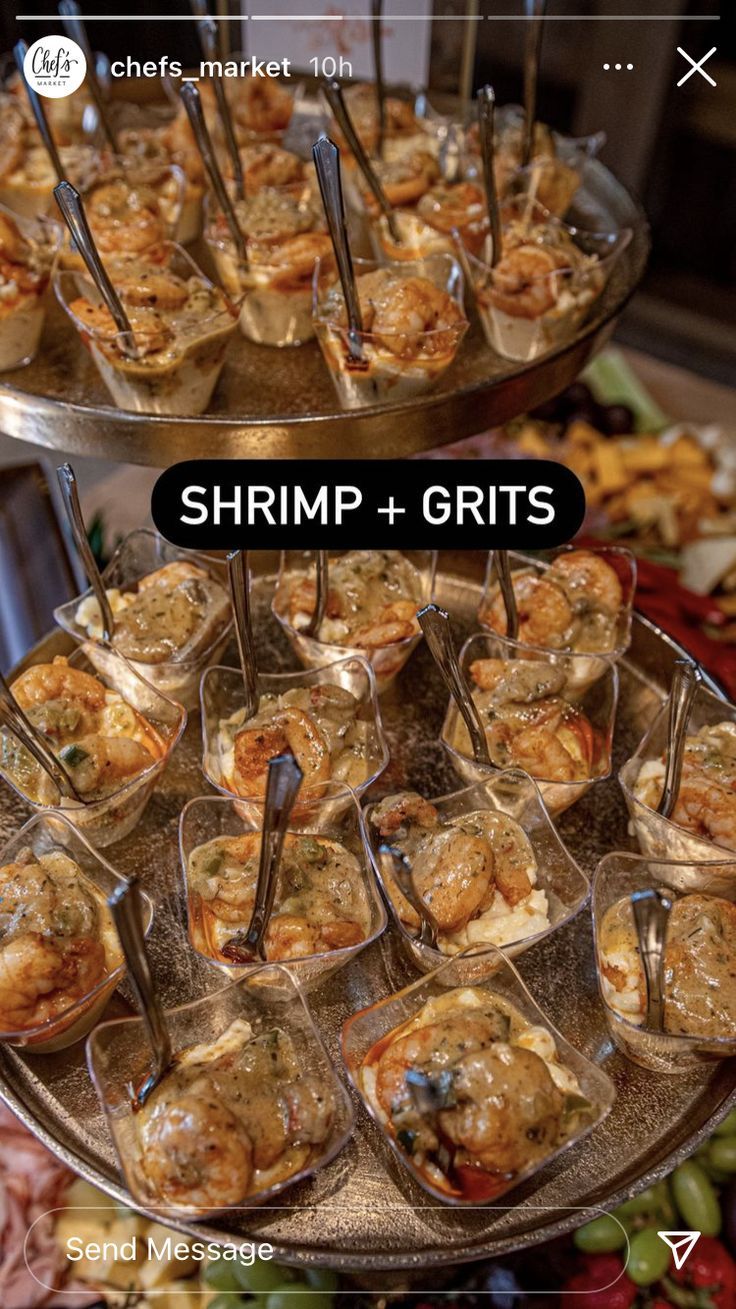 shrimp and grits are served in glass dishes on a platter with serving utensils