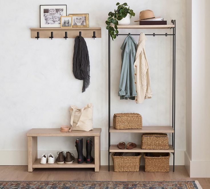 a coat rack with shoes and hats hanging on it next to a rug in a room