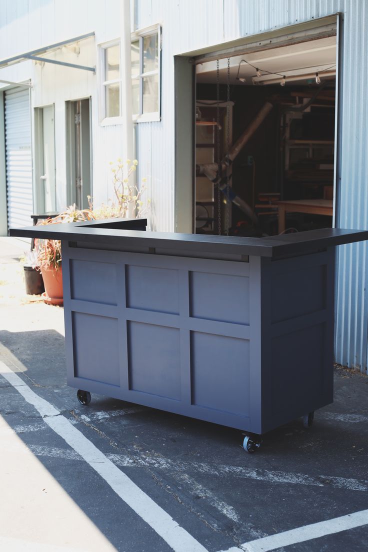 an outdoor bar on wheels in front of a building