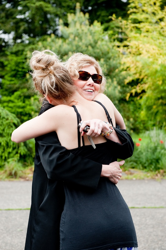 two women hugging each other in the street