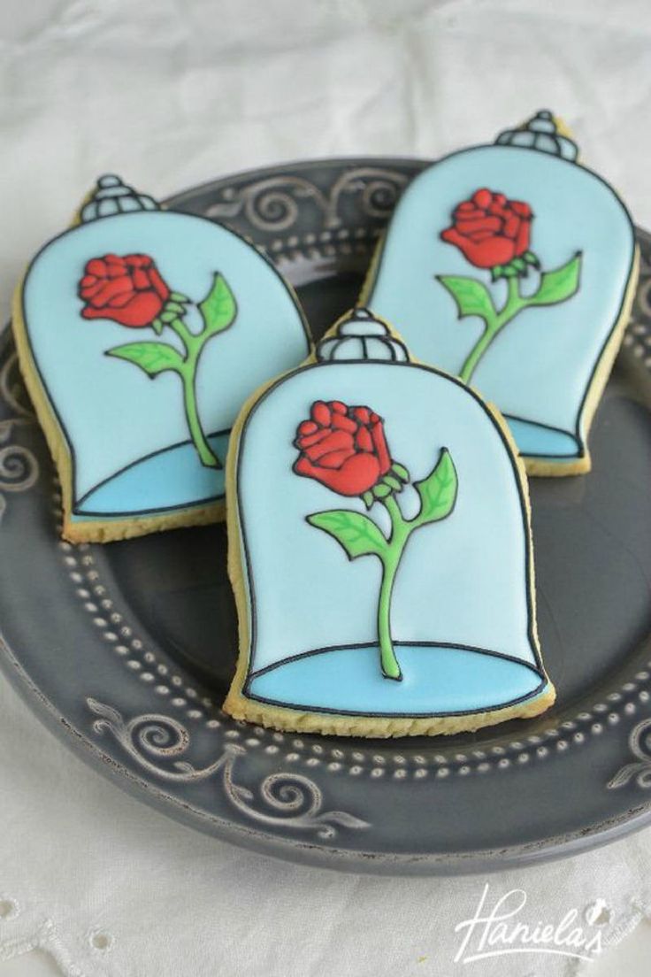 three decorated sugar cookies on a plate