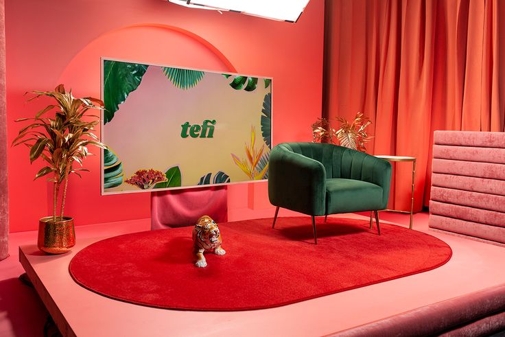 a living room with two chairs and a rug in front of a television screen that says teff on it