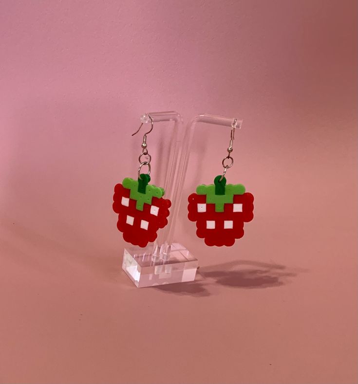 a pair of earrings made to look like fruit