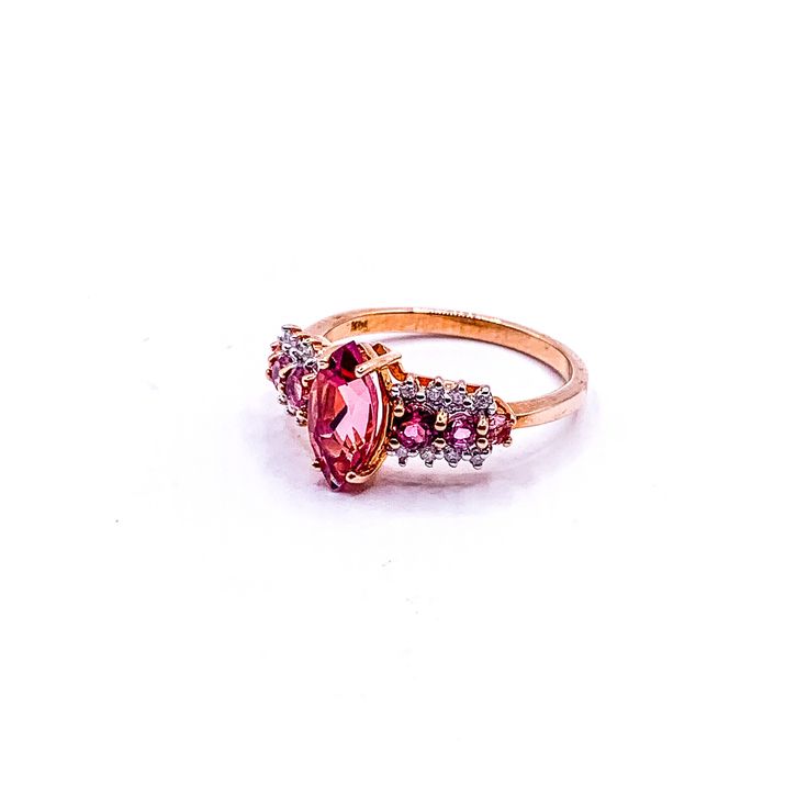 10mm by 5.5mm marquise cut center pink tourmaline. Round pink tourmalines and diamonds. 3 grams 14k yellow gold. Size 7. Pink Marquise Ring For Formal Occasions, Pink Marquise Ring For Anniversary, Formal Pink Marquise Ruby Ring, Pink Marquise Jewelry For Anniversary, Formal Marquise Pink Ruby Ring, Pink Marquise Ruby Ring For Formal Occasions, Pink Marquise Diamond Ring For Anniversary, Pink Marquise Cut Promise Ring, Pink Marquise Cut Rings For Formal Occasions