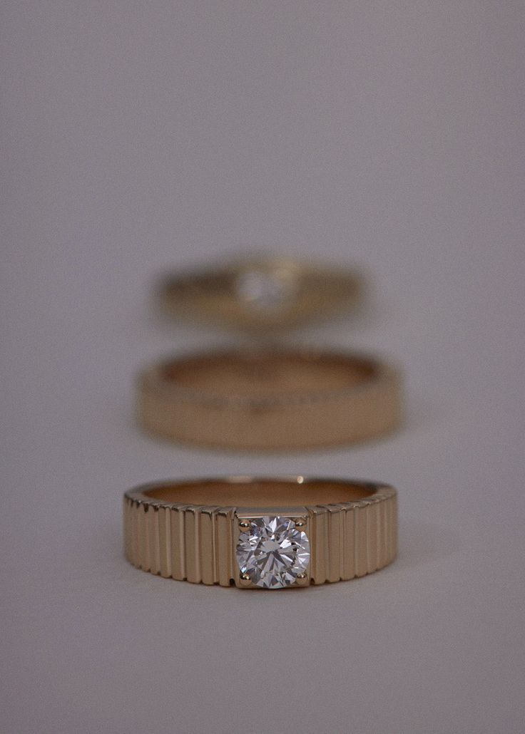 Inspired by Jennie's mother, Sun's vintage pleated ring, the Solis collection represents energy and strength. Features a round brilliant diamond prong set in a 14k solid gold ribbed band. This piece is not eligible for discounts. We also offer a variety of gemstones. Please email hey@kinnstudio.com to find out if we can source and set your desired gemstone. 14k solid gold—always. Non-hollow Weight: 5.37g Band width: 5mm (front), 3.5mm (back) Total carat weight: 0.50ctw Diamond cut: Round Brillia Diamond Ring With Fluted Bezel, Diamond Ring With Fluted Bezel And Round Cut, Diamond Rings With Fluted Bezel For Wedding, Timeless Jewelry With Fluted Bezel For Formal Occasions, Elegant Diamond Ring With Fluted Bezel For Anniversary, Timeless Round Ring With Single Diamond, Timeless Formal Jewelry With Fluted Bezel, Wedding Diamond Ring With Fluted Bezel, Timeless Round Single Diamond Ring