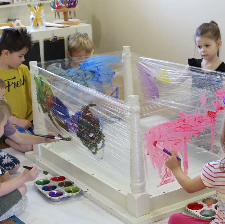 children are painting in an art class