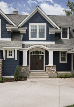 a house with blue siding and white trim on the front door is shown in an instagram