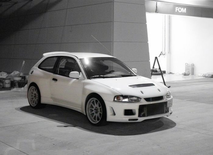 a white car parked in front of a building