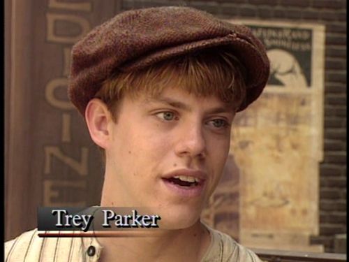 a young man wearing a brown hat with the words trey parker in front of him