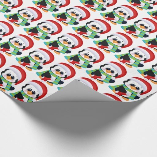 a christmas wrapping paper with santa's face and penguin on it, all over