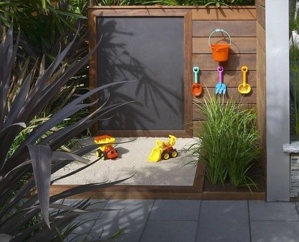 an outdoor play area with toys and sand