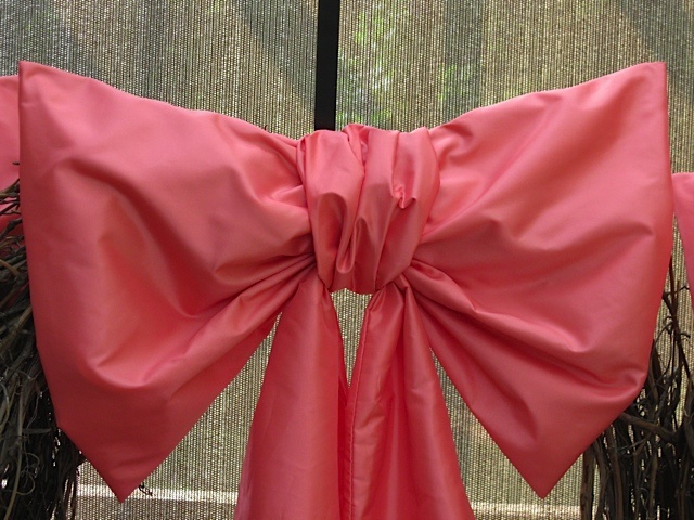 a pink bow tied to the side of a door