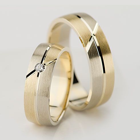 two gold wedding rings with diamonds on them