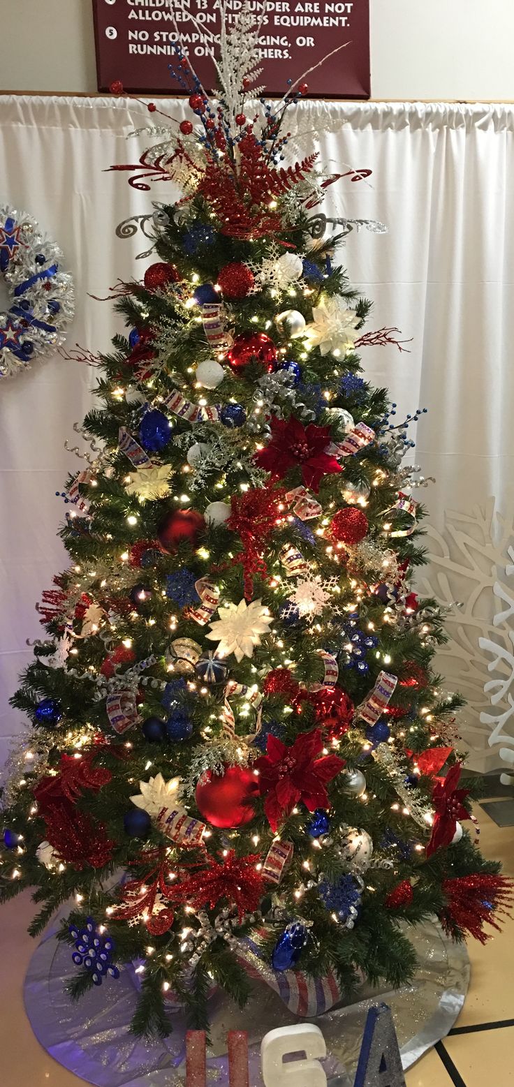 a decorated christmas tree with red, white and blue decorations