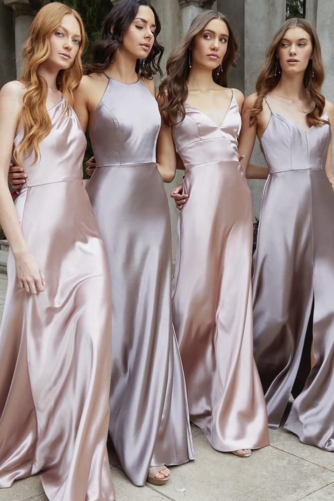 three women in long dresses standing next to each other