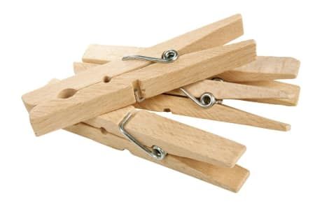 several wooden clothes pegs with metal clips