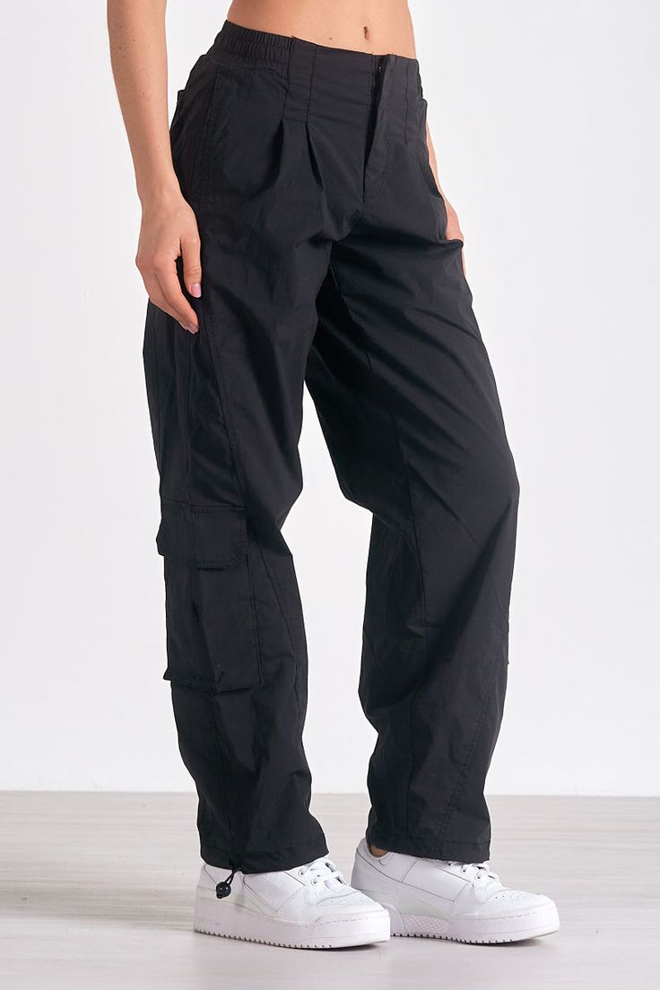 Channel utility-chic in Krystian pants. These cargo-style trousers feature large pockets and a parachute silhouette, with adjustable ankle drawstrings for versatile styling. Parachute Silhouette, Denim Dress Fall, Jumpsuit Coverup, Fall Bottoms, Dressy Earrings, Jumpsuit Fall, Pants With Elastic Waist, Style Trousers, Black Cargo Pants