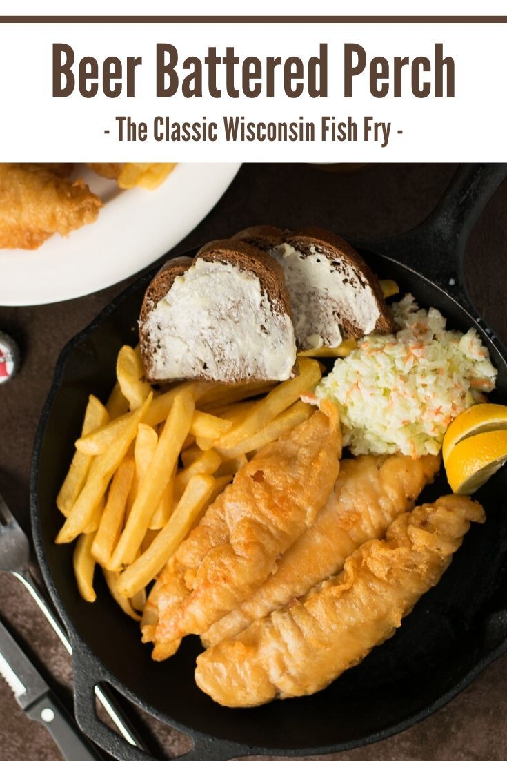 there is a plate with fish and french fries on it, along with other foods