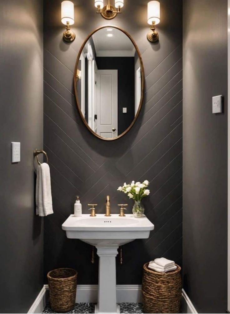 a white sink sitting under a mirror in a bathroom